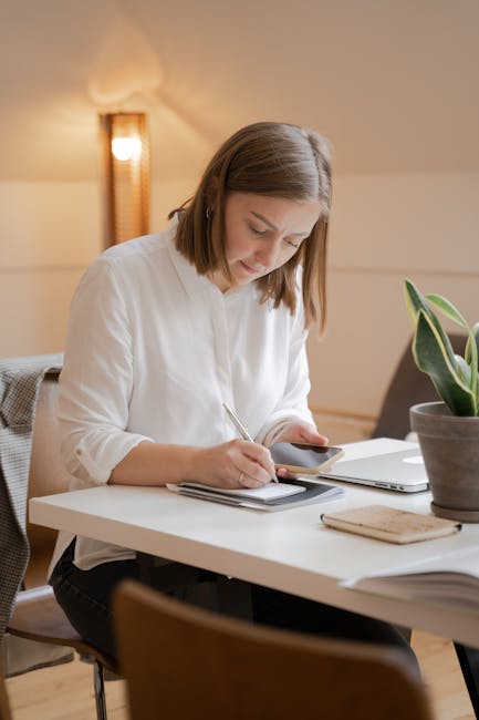 A person sitting at an office desk taking a short break to stretch their arms